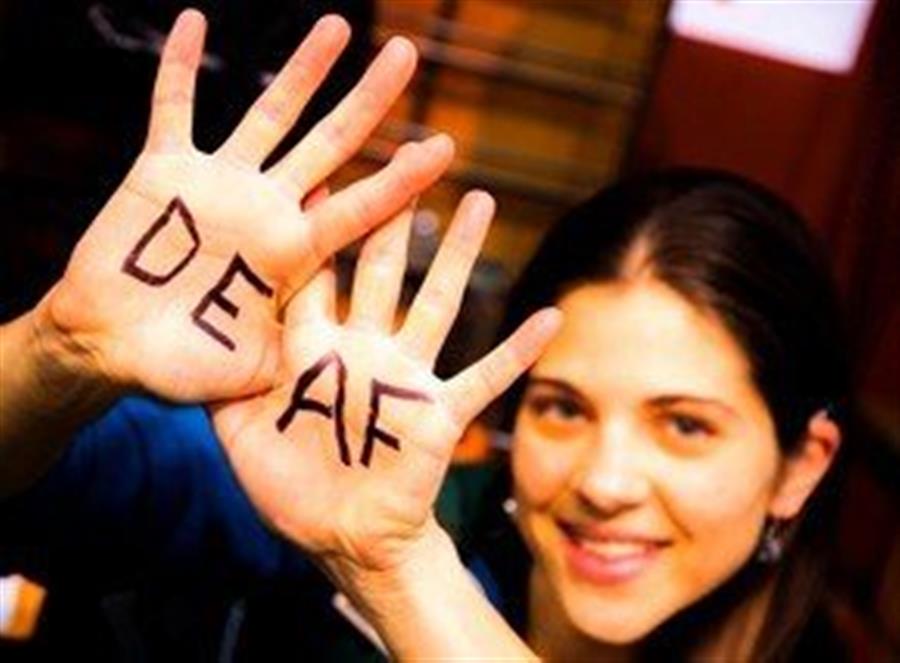 A woman holds up her hands. The word \